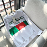 Flat lay presentation of Gucci luxury clothing with monogram-inspired silhouette
