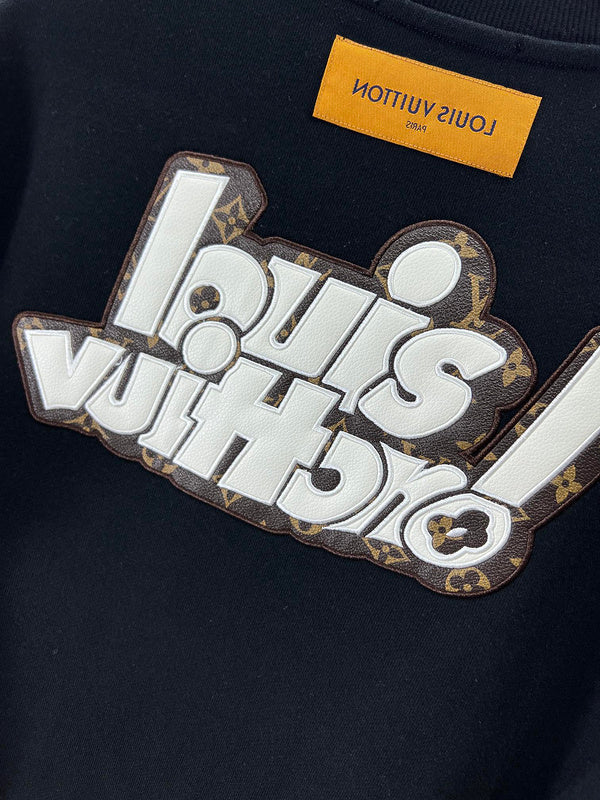 Close-up detail shot of Louis Vuitton luxury clothing with logo-detail design