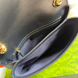 Side profile of signature polished women's handbag – women's luxury handbag