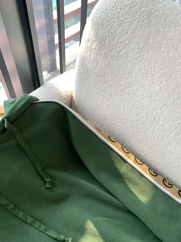 Flat lay presentation of Gucci luxury clothing with logo-detail design