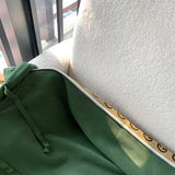 Flat lay presentation of Gucci luxury clothing with logo-detail design