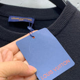 Full styled look of Louis Vuitton luxury clothing with label-forward styling