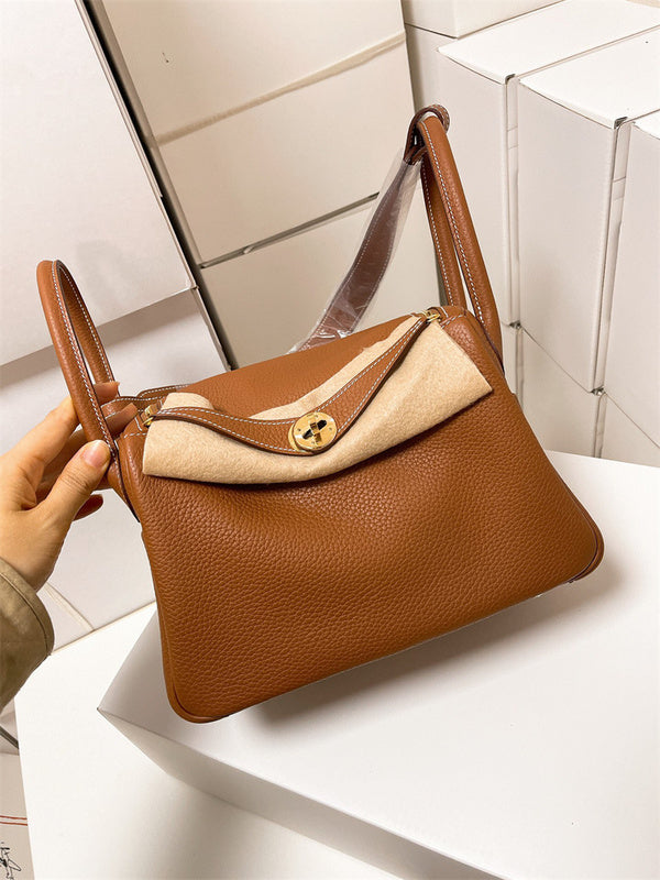  Timeless top-handle bag carried on shoulder