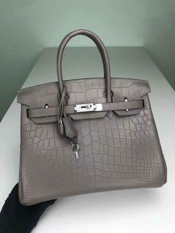 Side view of streamlined structured handbag