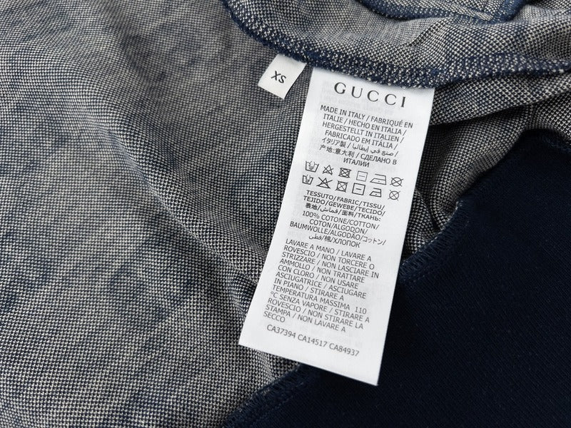Side profile of Gucci luxury clothing with logo-detail design