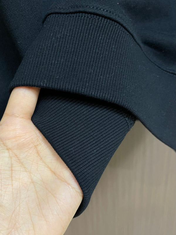 Close-up detail shot of Louis Vuitton luxury clothing with logo-detail design