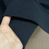 Close-up detail shot of Louis Vuitton luxury clothing with logo-detail design
