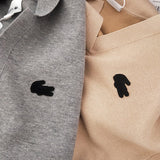 Side profile of Lacoste luxury clothing with monogram-inspired silhouette