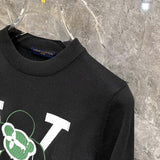 Close-up detail shot of Louis Vuitton luxury clothing with label-forward styling