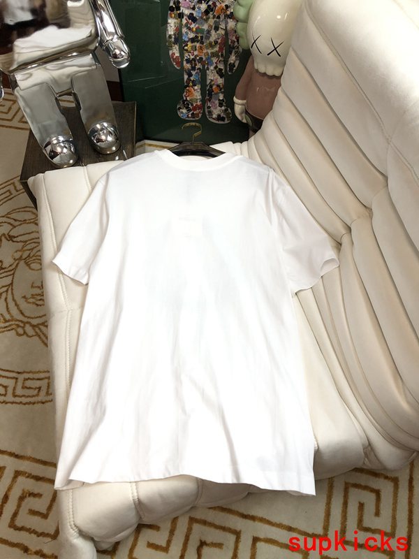 Flat lay presentation of Moncler luxury clothing with monogram-inspired silhouette