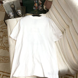 Flat lay presentation of Moncler luxury clothing with monogram-inspired silhouette