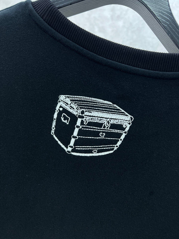 Close-up detail shot of Louis Vuitton luxury clothing with label-forward styling
