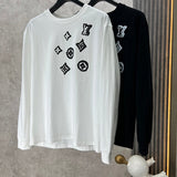 Close-up detail shot of Louis Vuitton luxury clothing with logo-detail design