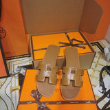 Hermès Red Crisscross Strap Sandals - Close-Up Texture View