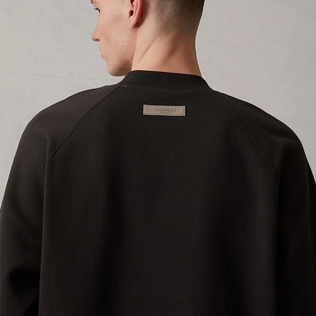 Side profile of Fear of God Essentials Sweatshirt showcasing structured silhouette