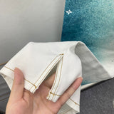 Flat lay presentation of Louis Vuitton luxury clothing with signature branding