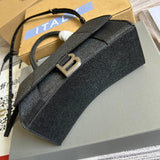 Styled lifestyle shot of classic signature women's handbag – women's designer-style accessory