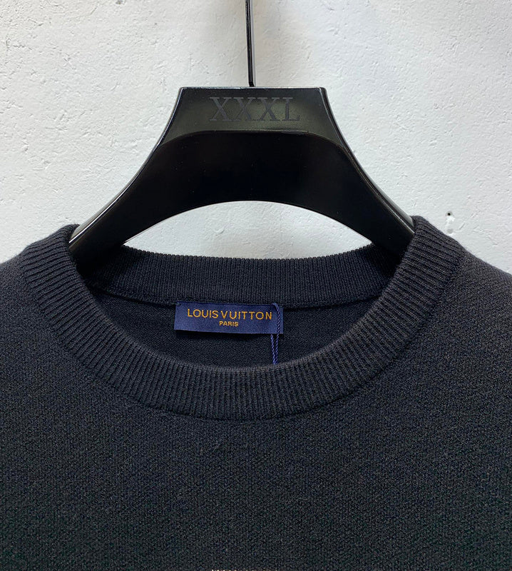 Close-up detail shot of Louis Vuitton luxury clothing with label-forward styling