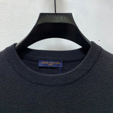 Close-up detail shot of Louis Vuitton luxury clothing with label-forward styling