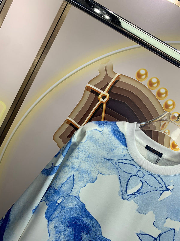 Flat lay presentation of Louis Vuitton luxury clothing with signature branding