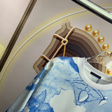 Flat lay presentation of Louis Vuitton luxury clothing with signature branding
