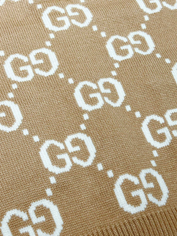 Close-up detail shot of Gucci luxury clothing with monogram-inspired silhouette