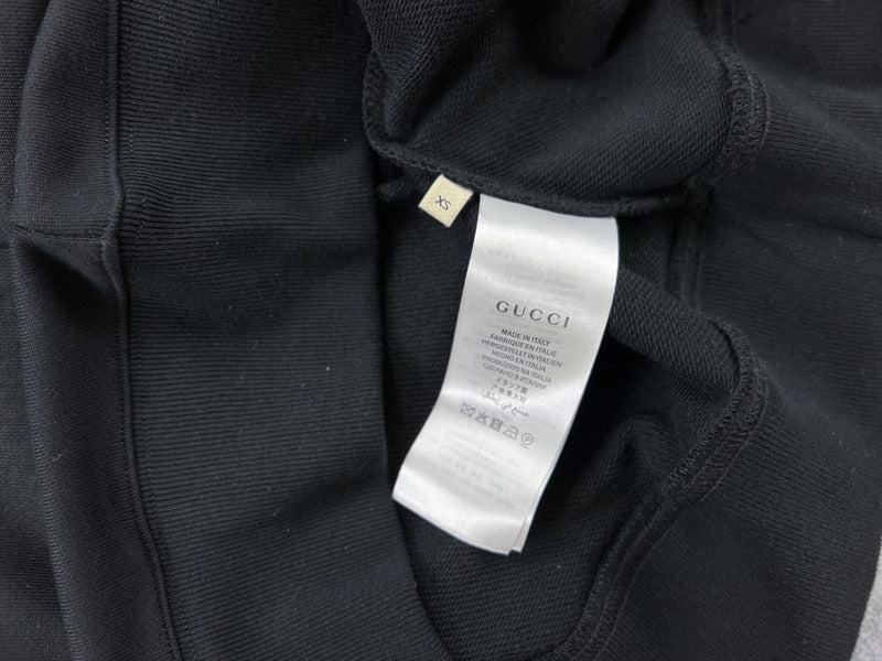 Front view of Gucci luxury clothing with signature branding