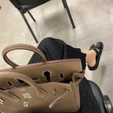 Side view of sophisticated structured handbag