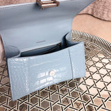 Side profile of polished classic women's handbag – women's luxury accessory