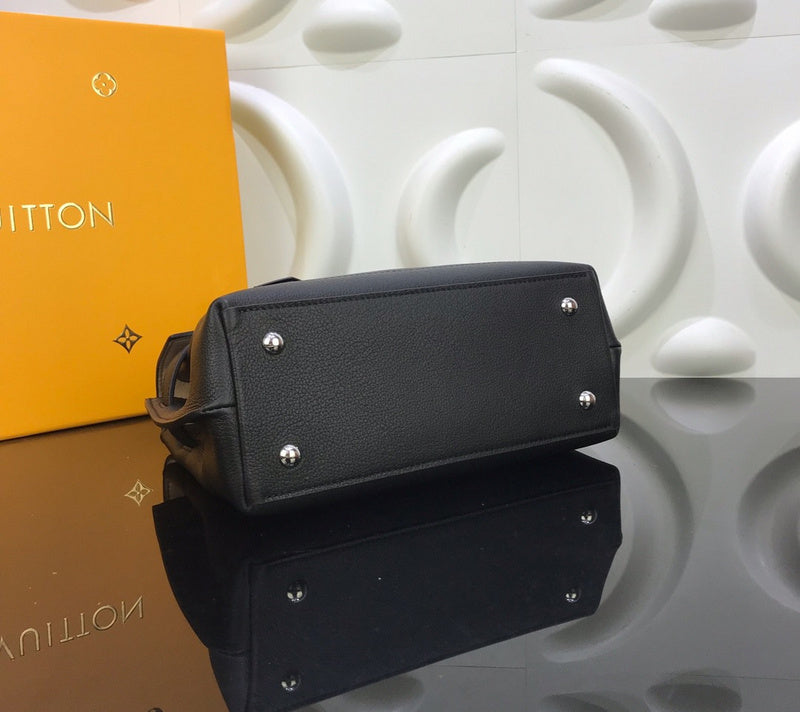 Styled lifestyle shot of polished signature women's handbag – women's designer-style accessory