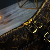 Handle and strap detail of polished structured women's handbag – women's luxury accessory