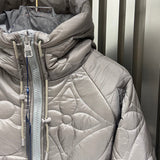 Close-up detail shot of Louis Vuitton luxury clothing with logo-detail design