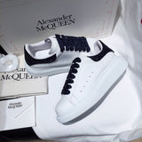 Side profile of Alexander McQueen crisp white sneakers cushioned comfort fit