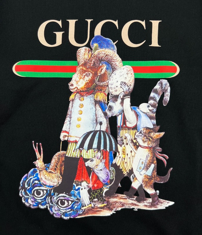 Flat lay presentation of Gucci luxury clothing with signature branding