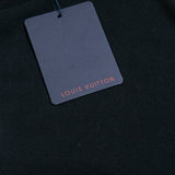 Flat lay presentation of Louis Vuitton luxury clothing with label-forward styling