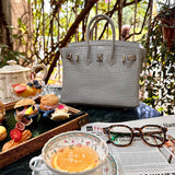 Side view of structured structured handbag