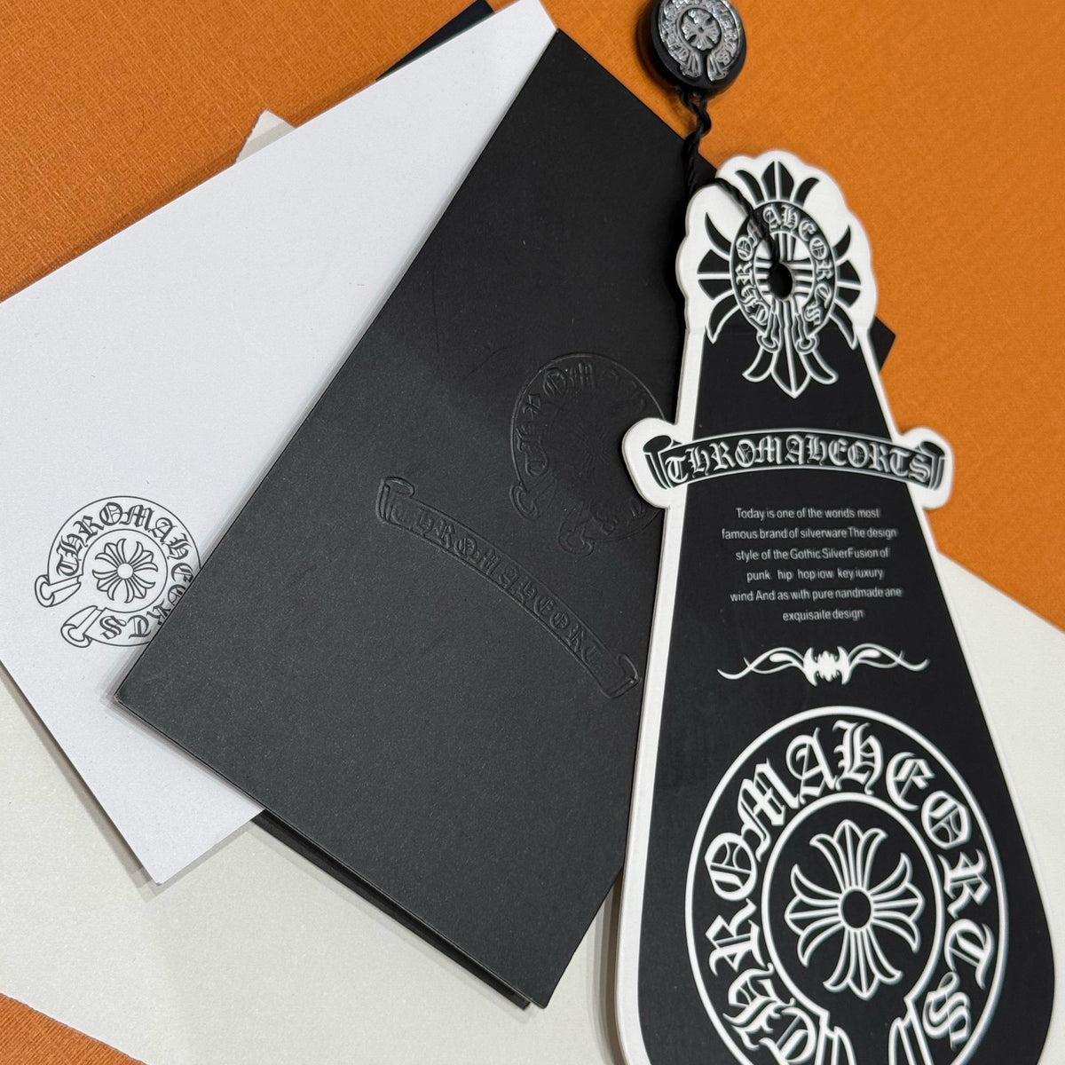 Chrome Hearts Jeans flat lay on neutral background