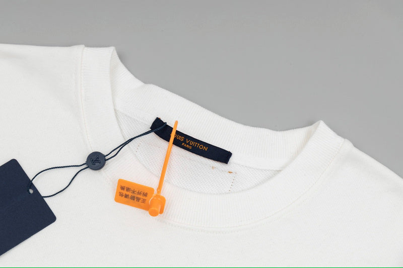 Close-up detail shot of Louis Vuitton luxury clothing with signature branding