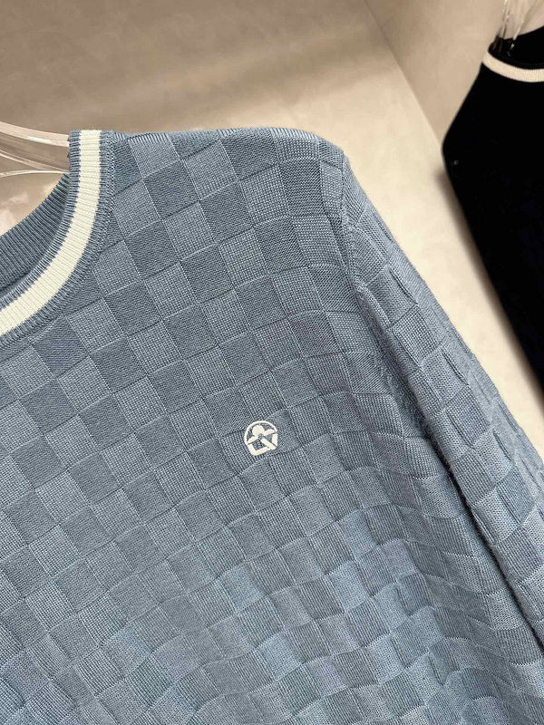 Flat lay presentation of Louis Vuitton luxury clothing with signature branding