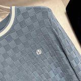 Flat lay presentation of Louis Vuitton luxury clothing with signature branding