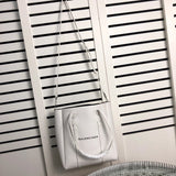 Styled lifestyle shot of modern refined women's handbag – women's statement bag