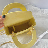 Styled lifestyle shot of structured signature women's handbag – women's designer-style accessory