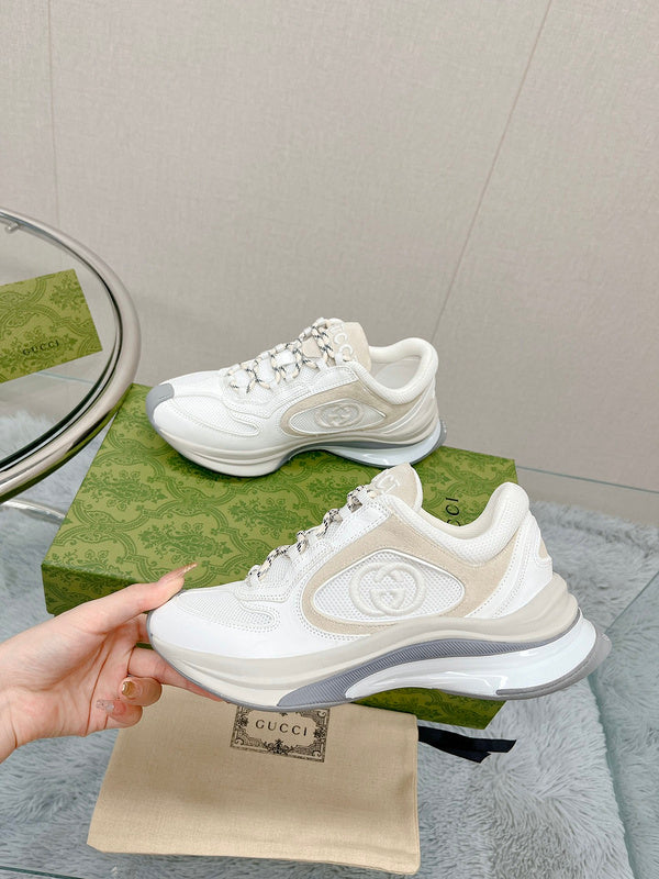 Gucci Designer sneakers in muted earth tones retro runner design front view