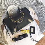 Front view of polished elevated women's handbag – women's luxury accessory