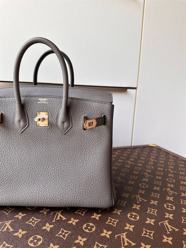  polished top-handle bag styled with outfit