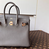 polished top-handle bag styled with outfit