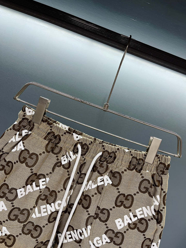Flat lay presentation of Gucci luxury clothing with monogram-inspired silhouette
