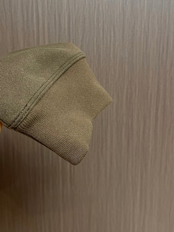 Side profile of Louis Vuitton luxury clothing with signature branding