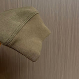 Side profile of Louis Vuitton luxury clothing with signature branding