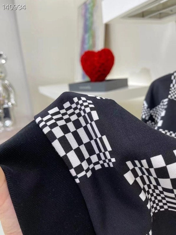 Flat lay presentation of Louis Vuitton luxury clothing with runway-inspired design